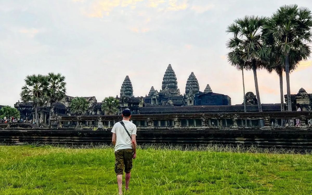 A traveller walking alone towards Angkor Wat, Cambodia