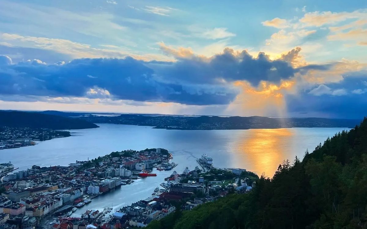 Low summer sun over a Norwegian fjord and city